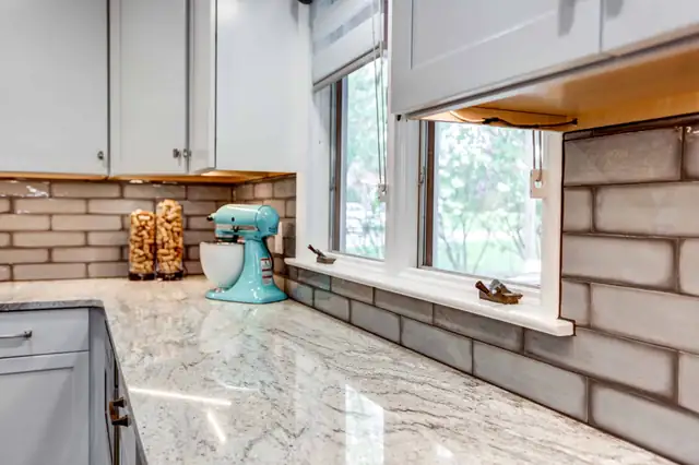 Manheim, PA kitchen remodel with white cabinets, granite counters and an island with stools
