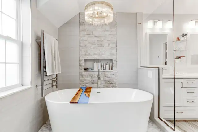 Bathroom remodel in a Manheim, PA home with a tub, accent wall and chandelier